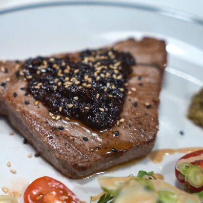 Golden-brown-grilled-tna-steak-with-orange-and-green-side-salad